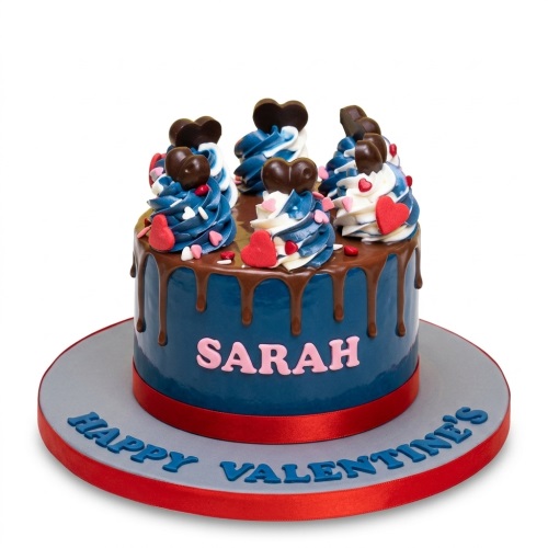 Round blue drip cake with chocolate hearts, red hearts, and sprinkles, featuring a custom name in pink.