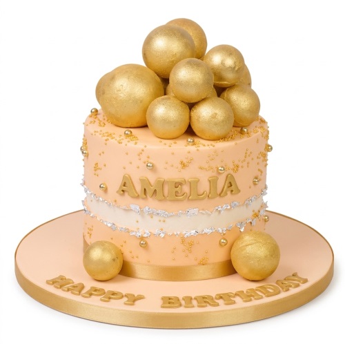 Elegant single-tier birthday cake with gold spheres, gold sprinkles, silver leaf, and a personalised name.