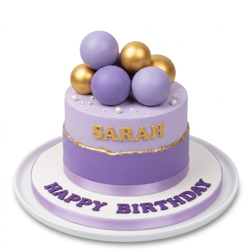 Two-tier purple and gold birthday cake with decorative spheres and pearl sprinkles