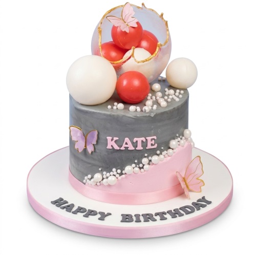 Round grey and pink birthday cake with butterflies, spheres, and pearls.