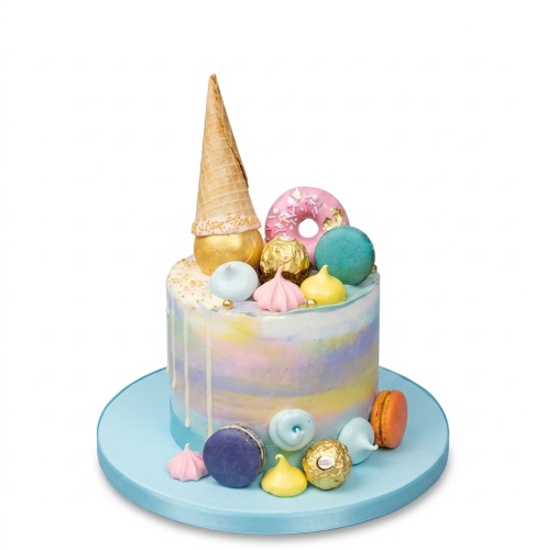 Pastel drip birthday cake with ice cream cone, donut, macarons, meringues, and chocolates.