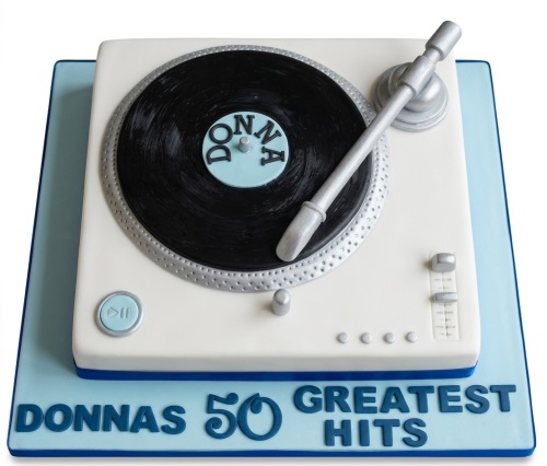 White and black turntable birthday cake with silver details and custom message board.