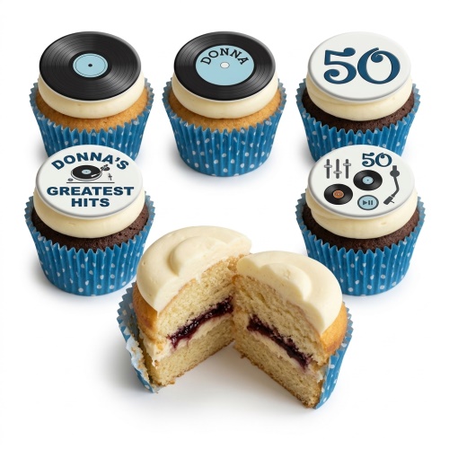 Assorted cupcakes with blue polka dot wrappers, white icing, and black vinyl record and record player toppers with custom age.