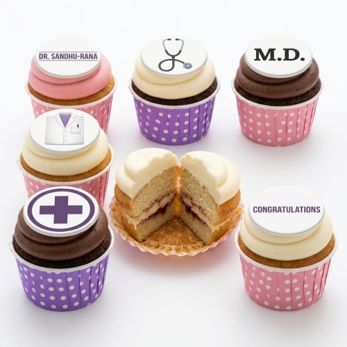 Assortment of doctor theme cupcakes with stethoscope, lab coat, medical cross, and "M.D." toppers.