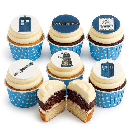 Doctor Who themed cupcakes with TARDIS, Dalek, and Sonic Screwdriver toppers on vanilla and chocolate sponge.
