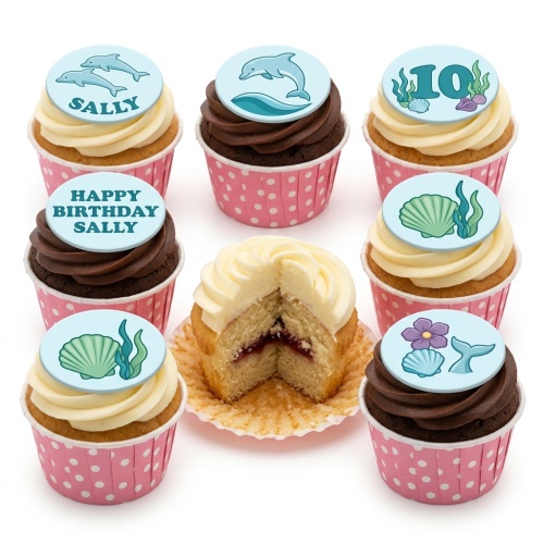 Under the sea themed cupcakes with dolphins, seashells, mermaid tail, and a custom age topper.