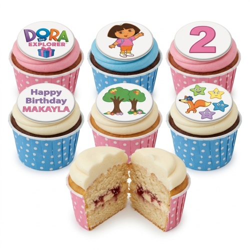 Dora the Explorer themed cupcakes with various edible toppers including Dora, trees, a fox with stars, and a custom age topper.