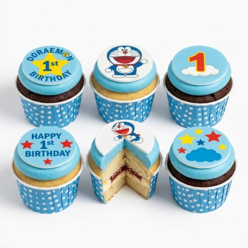 Six Doraemon themed 1st birthday cupcakes with blue frosting, character toppers, stars, clouds, and '1st Birthday' messages.