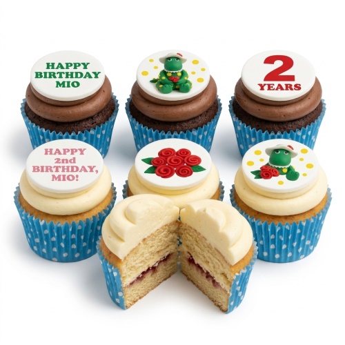 A selection of dinosaur and rose themed birthday cupcakes with custom age and message toppers.