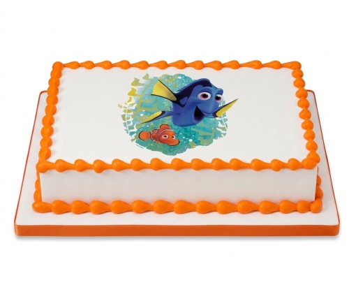 Rectangular white birthday cake with orange piping and an edible image of Dory and Nemo.