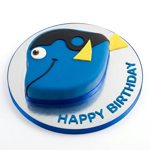 Blue Dory character birthday cake with yellow fins and a 'Happy Birthday' message on the cake board.