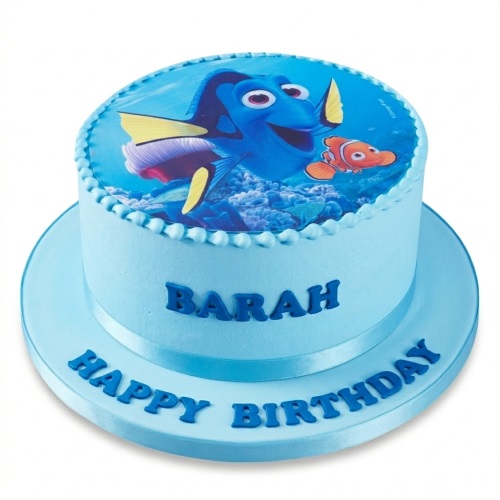 Round Dory and Nemo themed birthday cake with blue icing and a custom 'Happy Birthday' message.