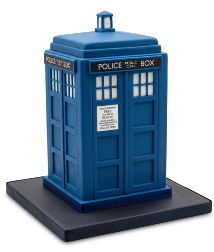 Blue Doctor Who TARDIS shaped birthday cake with white windows and black base.