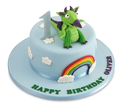 Light blue fondant cake with a green dragon, rainbow, clouds, and a custom age topper.