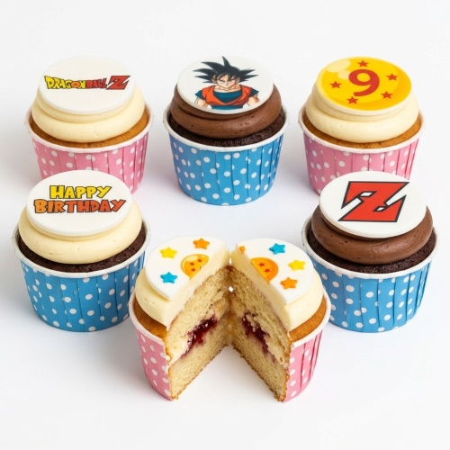 Dragon Ball Z themed cupcakes with Goku, Z logo, Dragon Ball Z logo, and a custom age 9 topper, in blue and pink polka dot wrappers.