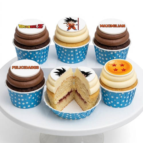 Dragon Ball Z themed cupcakes with Goku, logo, and Dragon Ball toppers in blue polka dot wrappers.
