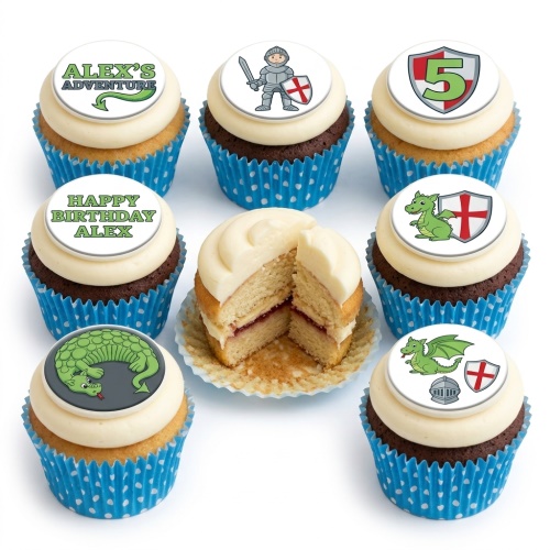 Cupcakes with white frosting and blue polka dot wrappers, topped with edible knight and dragon adventure themed designs, including custom age shield.
