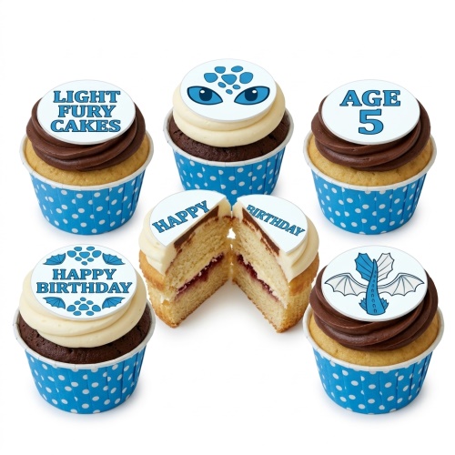 How to Train Your Dragon themed cupcakes with dragon eyes, wings, and custom age topper on blue polka dot wrappers.