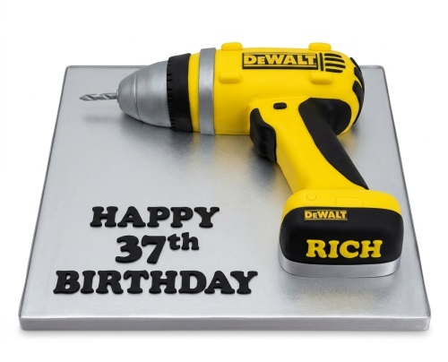 3D sculpted DeWalt drill theme birthday cake on a silver board with custom age and name.