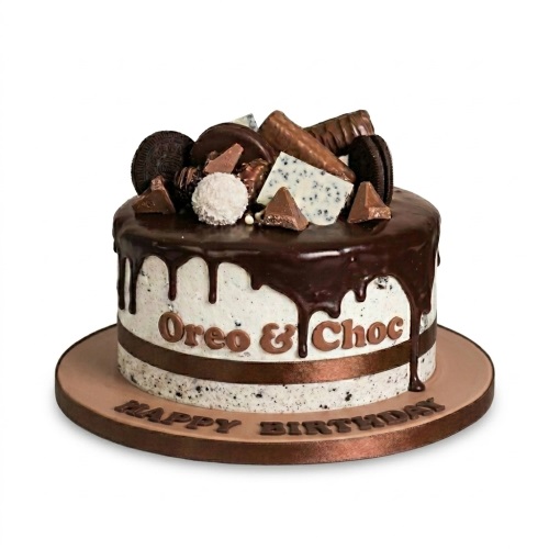 Round Oreo and chocolate drip birthday cake with assorted chocolates and 'Happy Birthday' message.