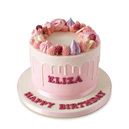 Pink birthday cake with white drip, meringues, and berries, ready for personalisation.