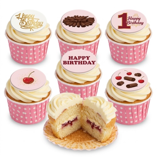 A selection of birthday cupcakes with white frosting and pink polka dot cases, featuring various toppers like 'Happy Birthday', chocolate curls, cherries, and a '1 Happy Birthday' design.