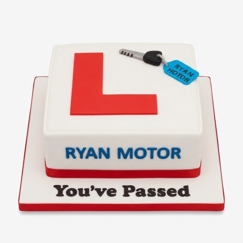 White square cake with a red L-plate, a car key, and 'You've Passed' message.