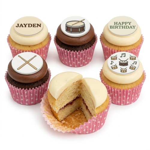 Assortment of drum kit themed birthday cupcakes with white and chocolate frosting, featuring drum and drumstick toppers.