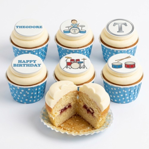 Drum theme birthday cupcakes with blue polka dot cases and custom toppers.