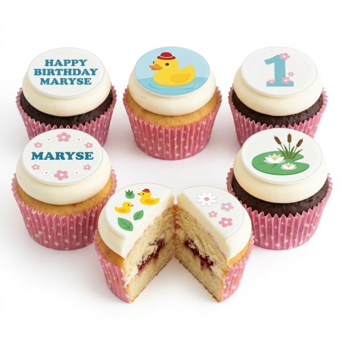 Cupcakes with rubber duck, lily pad, and custom age toppers in pink wrappers.