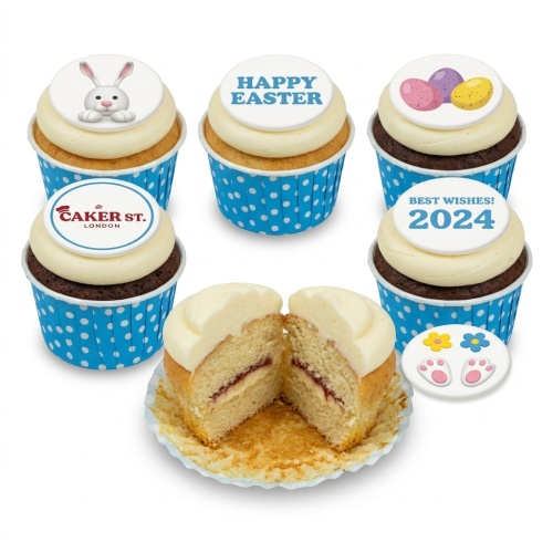 Easter cupcakes with bunny, Happy Easter, and egg toppers, with a cut vanilla cupcake showing jam filling.