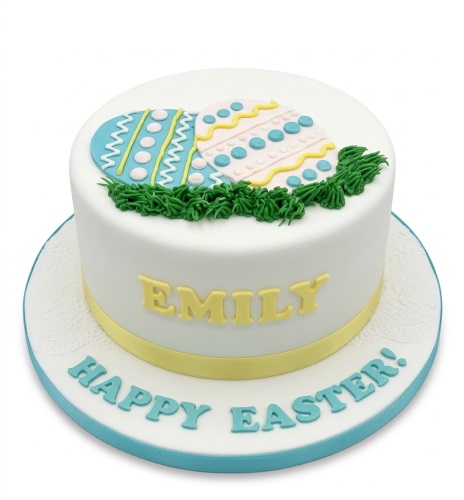 White round cake with blue and yellow decorated Easter eggs, green grass, and a yellow ribbon.
