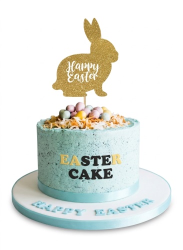 Light blue Easter cake with gold glitter bunny topper, pastel mini eggs, and 'EASTER CAKE' lettering.