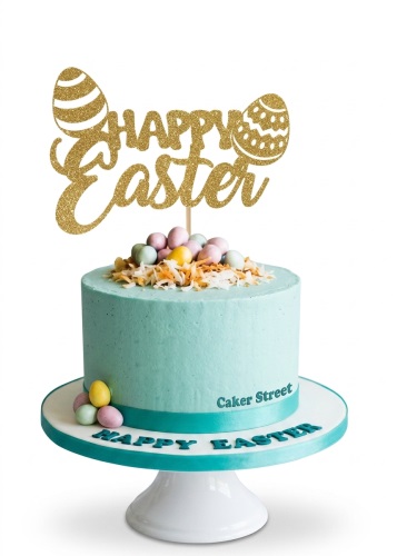 Round teal Easter cake with gold 'Happy Easter' topper, pastel mini eggs, and toasted coconut flakes.
