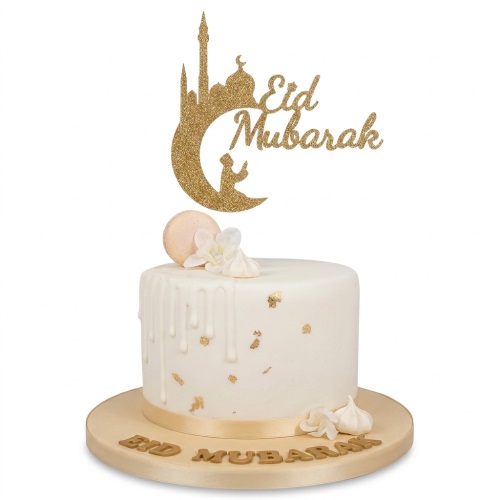 White Eid Mubarak cake with gold mosque topper, drip icing, and gold accents.
