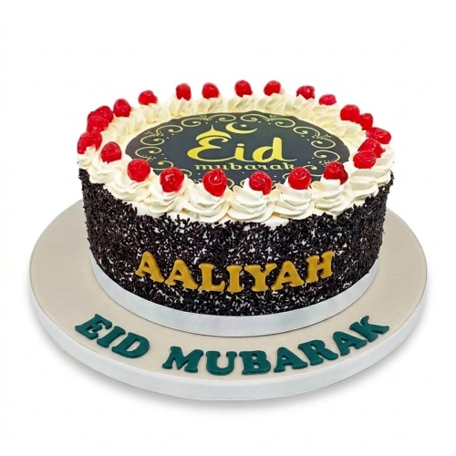 Round Eid Mubarak cake with chocolate sprinkles, cream, cherries, and a personalised name.