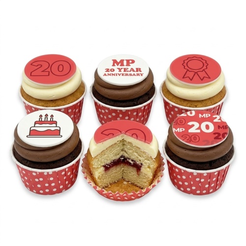 A selection of 20th Anniversary Celebration Cupcakes with red and white toppers, some showing '20', a cake, and a ribbon.
