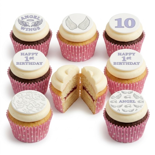 Cupcakes with cream frosting and pink polka dot wrappers, featuring white toppers with angel wings, 'Angel Wings', 'Happy 1st Birthday', '10', and swirl designs.