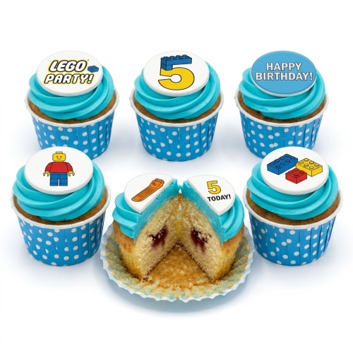 Blue frosted cupcakes with white building block theme toppers and custom age.