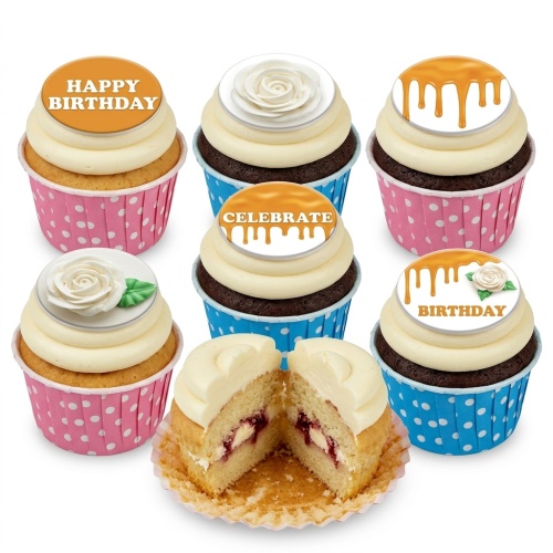 Assorted birthday cupcakes with white frosting, floral roses, and caramel drip toppers in pink and blue wrappers.