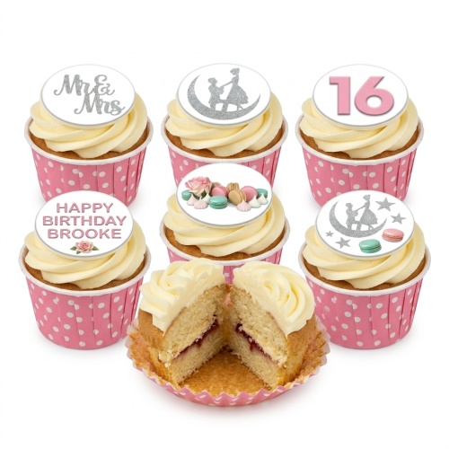 Vanilla cupcakes with white buttercream, pink polka dot wrappers, and customisable toppers featuring floral, macaron, and age designs.