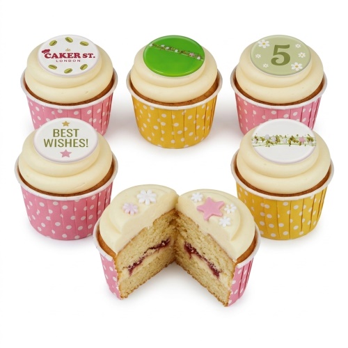 Vanilla cupcakes with cream frosting, floral and star sugar decorations, and custom age toppers.