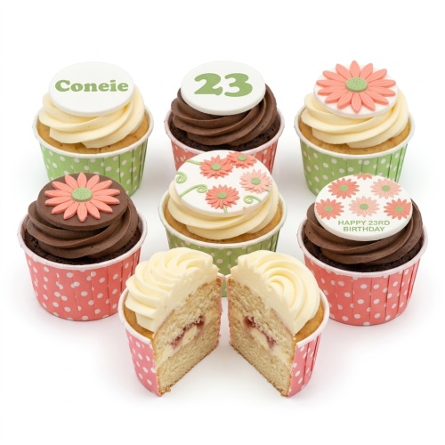 Assortment of floral birthday cupcakes with custom age and name toppers.