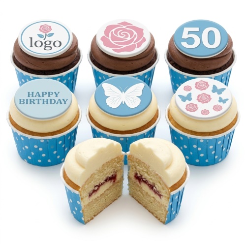 Assortment of floral and butterfly birthday cupcakes with custom age and 'Happy Birthday' toppers in blue cases.