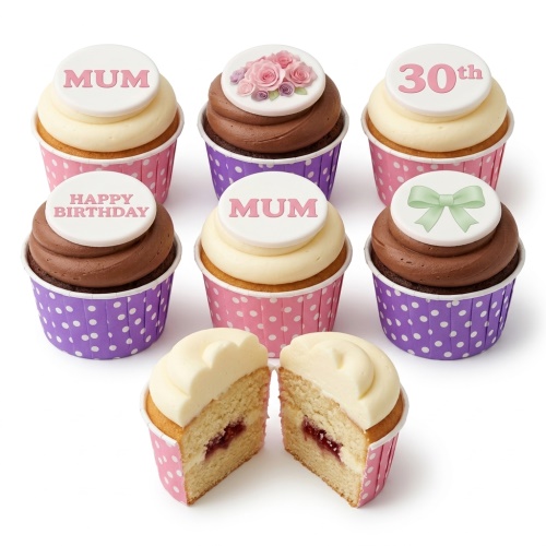 Assortment of birthday cupcakes with floral, bow, and custom message toppers, in pink and purple polka dot cases.