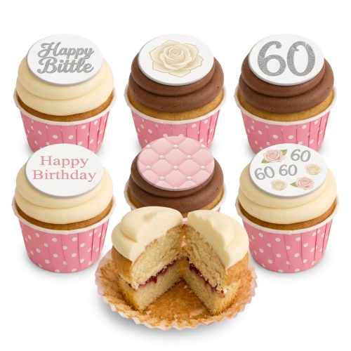 Elegant birthday cupcakes with pink and white polka dot wrappers, featuring floral, quilted, and custom age/message toppers.