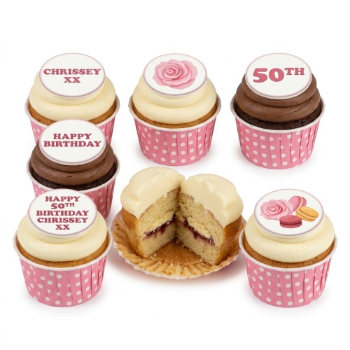 Assortment of birthday cupcakes with floral, macaron, and custom age toppers in pink wrappers.