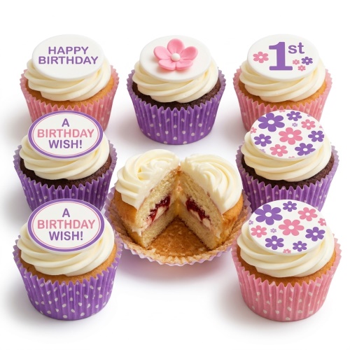 Assortment of pink and purple floral birthday cupcakes with custom age and message toppers.