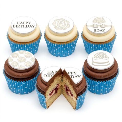 A selection of birthday cupcakes with white and chocolate frosting, decorated with white edible toppers featuring floral designs and 'Happy Birthday' messages.