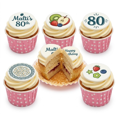 Vanilla cupcakes with white frosting, pink polka dot wrappers, edible fruit designs, and custom age toppers.